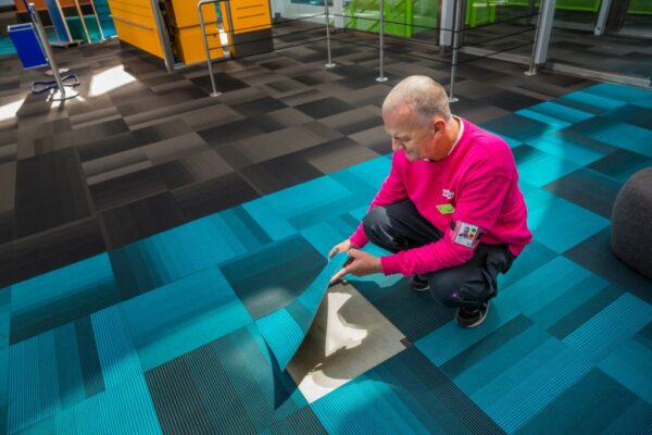 Man lägger matta på golv